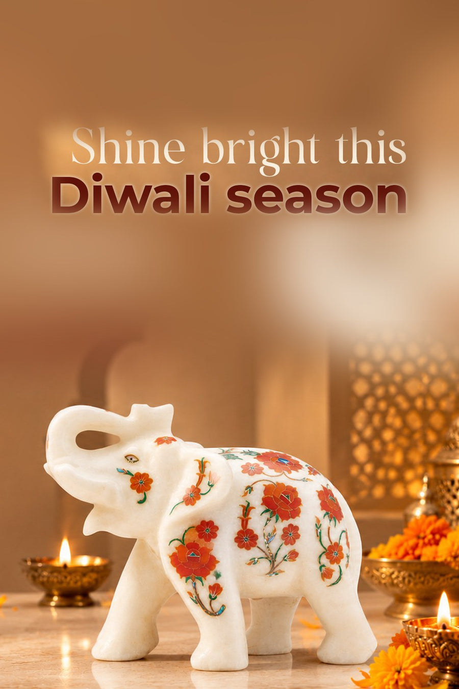 Shine bright this Diwali season: a white marble elephant with carnelian inlay among brass diyas and marigolds