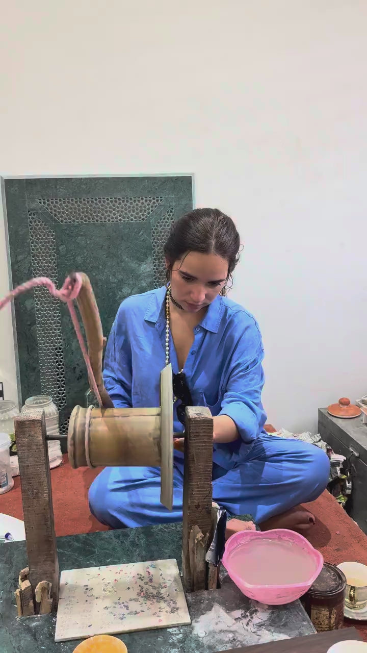 Guest working the stone-cutting wheel at the workshop
