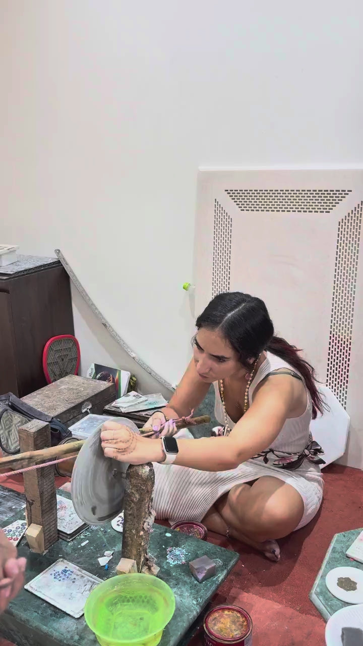 Guest shaping an inlay stone on the grinding wheel
