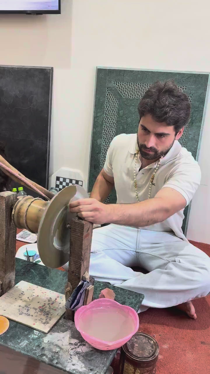 Visitor grinding inlay stone on the traditional wheel