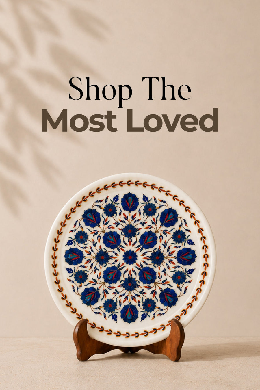Shop The Most Loved: a white marble plate with blue lapis floral inlay on a wooden stand